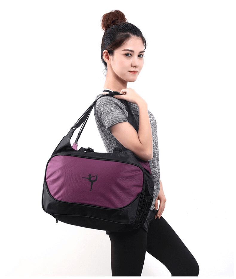 Woman carrying a purple multifunctional waterproof sport bag with mat clip, ideal for fitness and outdoor enthusiasts.