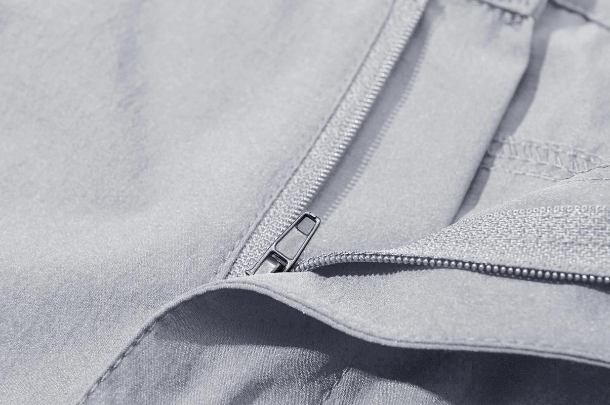 Close-up of zipper-fly closure on waterproof hiking pants for men, showcasing sleek design and durable material.