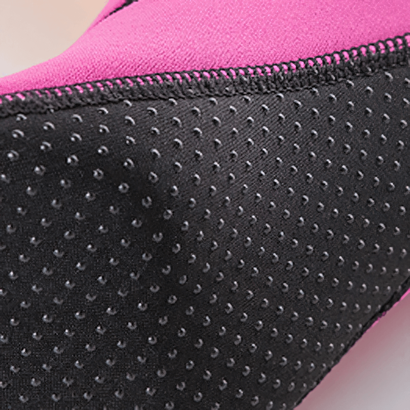 Close-up of pink and black non-slip beach shoe with rubber sole for diving and water activities.