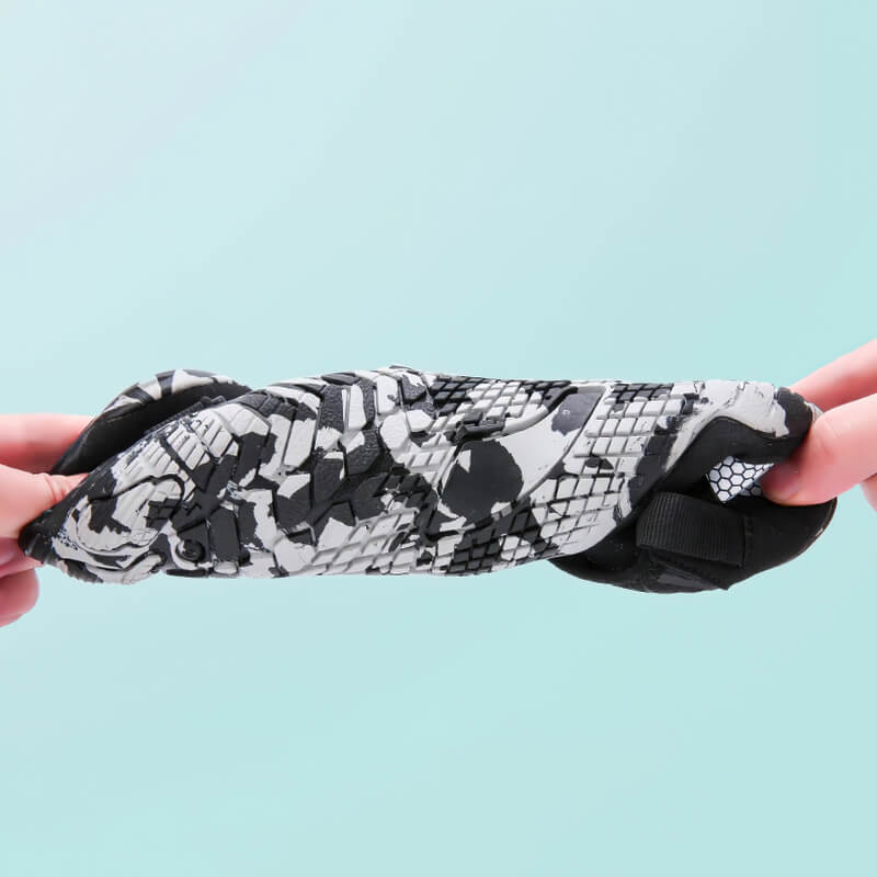 Non-slip breathable aqua shoes folded, showcasing flexibility and unique black and white pattern for swimming and fishing.