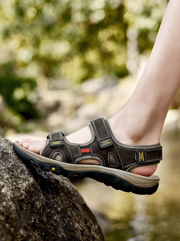 Open toe tactical leather men's sandal with adjustable velcro, showing flat heel and solid design. Perfect for leisure in rugged nature.