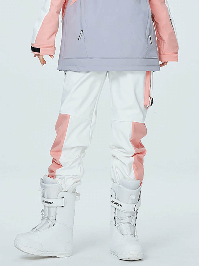 Person wearing white ski pants with pink accents and snow boots, showcasing outdoor windproof design and elastic waistband.