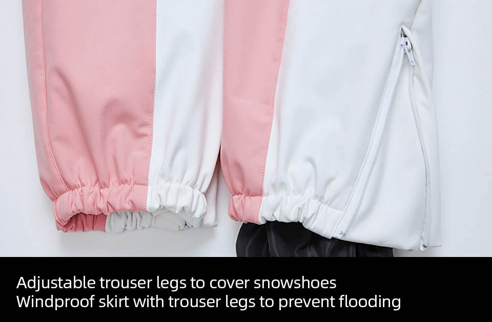 Close-up of windproof ski pants with adjustable legs in pink and white, showcasing elastic bands and a zipper pocket.