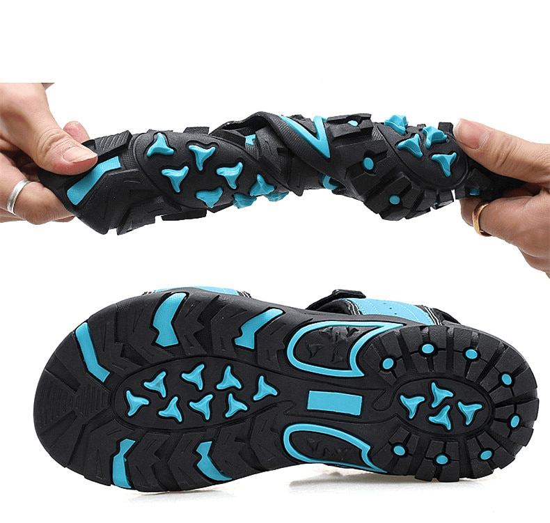 Flexible non-slip men's sandals with turquoise accents showing flexibility and detailed grip pattern on the rubber sole.