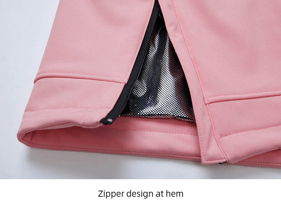 Close-up of pink outdoor jacket with black waterproof zipper at hem, showcasing durable and stylish design.