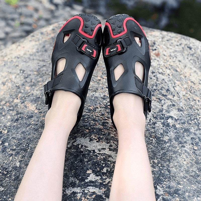 Outdoor men's soft sole water sandals with secure hasp, featuring EVA upper and rubber outsole, resting on rocky terrain.