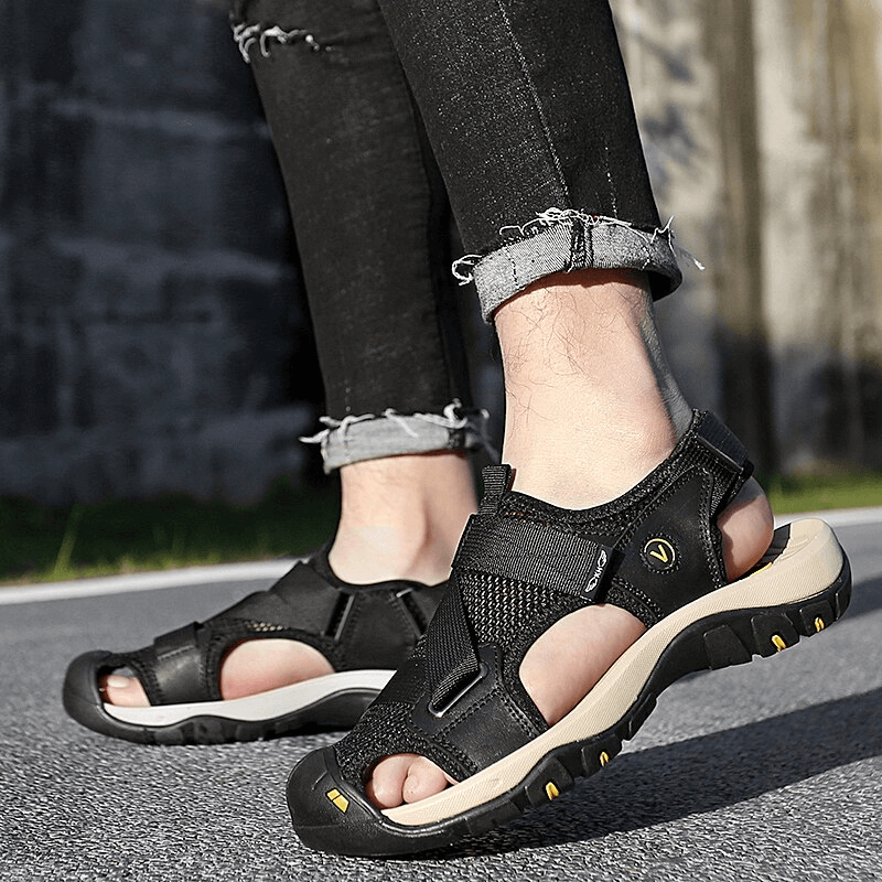 Outdoor mesh breathable sandals with Velcro closure and rubber outsole, worn by a person on a road, ideal for active lifestyles, model SF1097.