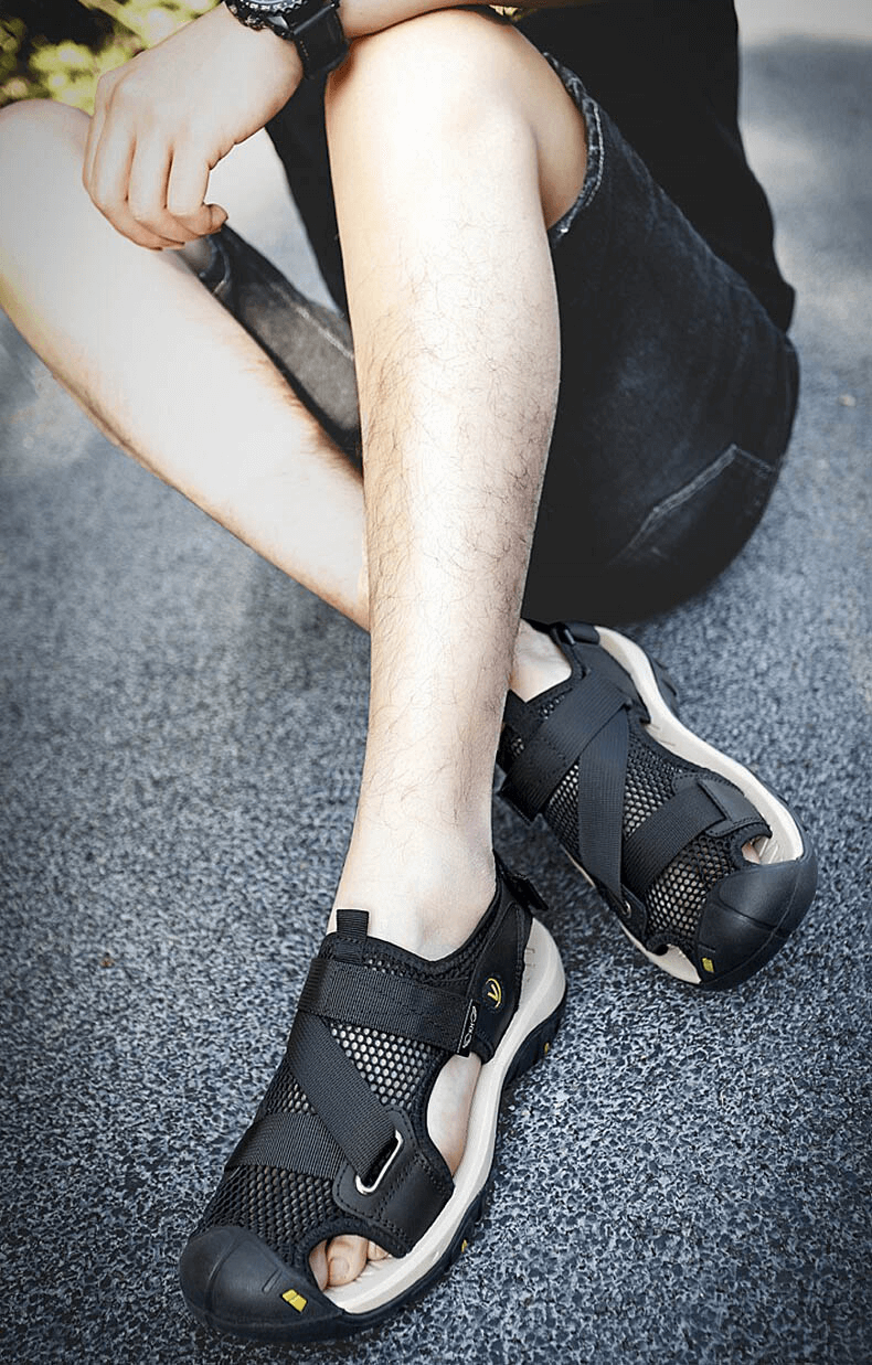 Outdoor mesh breathable sandals with Velcro and rubber outsole, perfect for active lifestyles. Style SF1097, worn on a seated person outdoors.