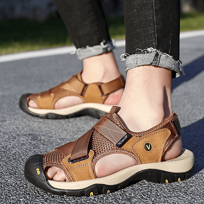 Outdoor mesh breathable sandals with Velcro closure, shown worn outdoors, featuring a rubber outsole and PU leather insole for comfort.