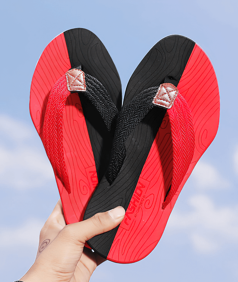 Bright red and black outdoor non-slip slide beach flip flops for men with thick rubber outsoles and breathable polyester straps.