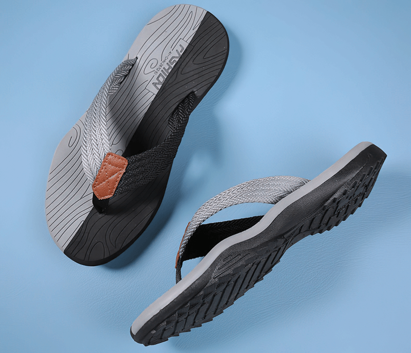 Outdoor non-slip beach flip flops for men with thick rubber sole on blue background, showcasing sleek design and comfort.