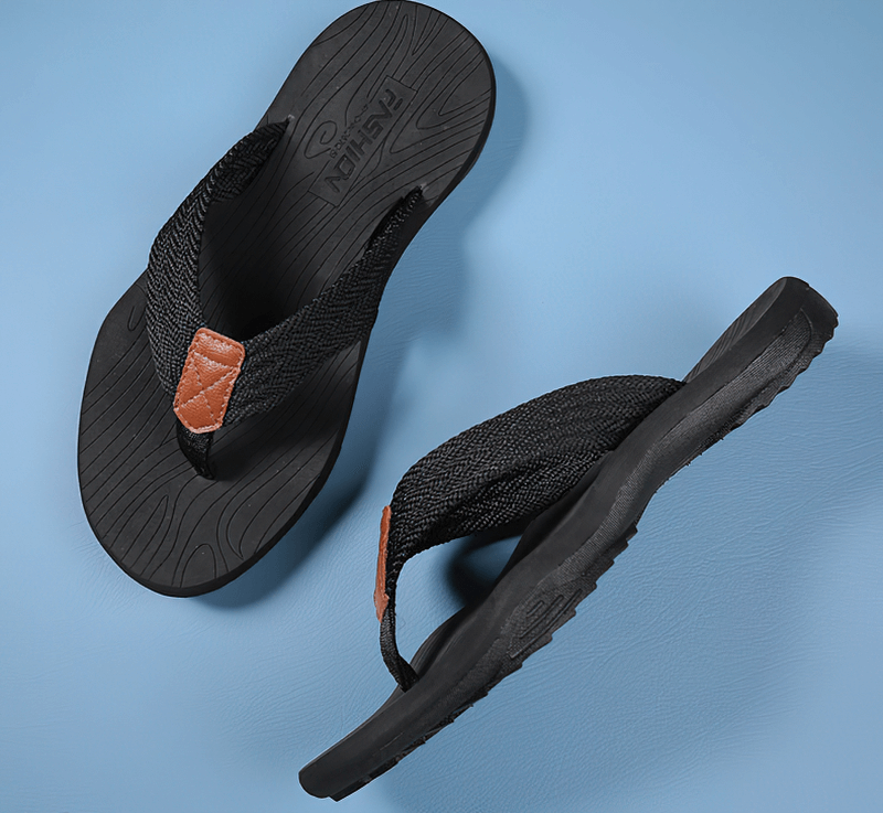Black non-slip beach flip flops for men with thick rubber soles and polyester straps, shown on a blue background.