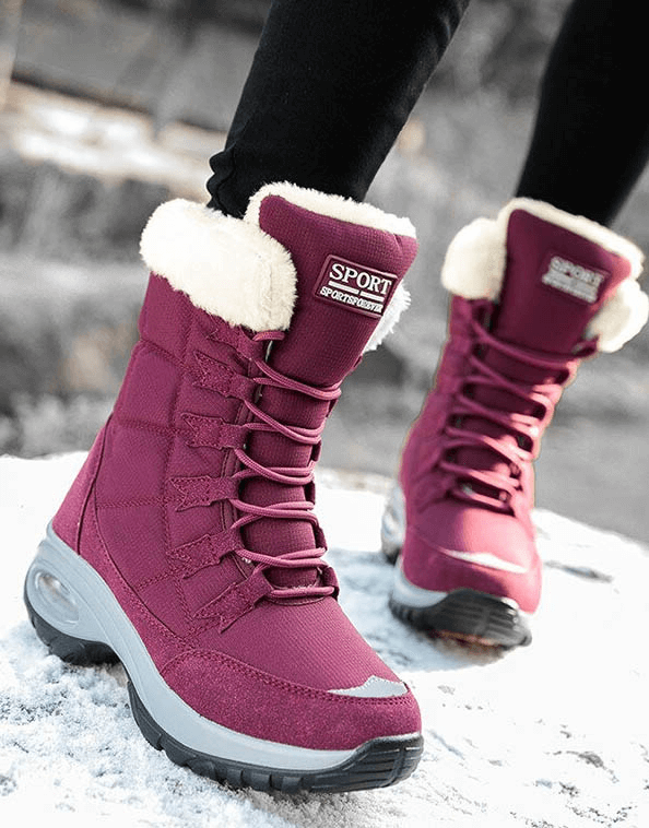 Stylish women's waterproof snow boots, maroon with fur trim, perfect for warm, comfortable winter trekking and icy terrain.