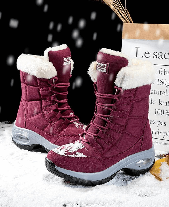 Women's waterproof snow boots, burgundy with white fur lining, perfect for winter trekking and icy terrains.