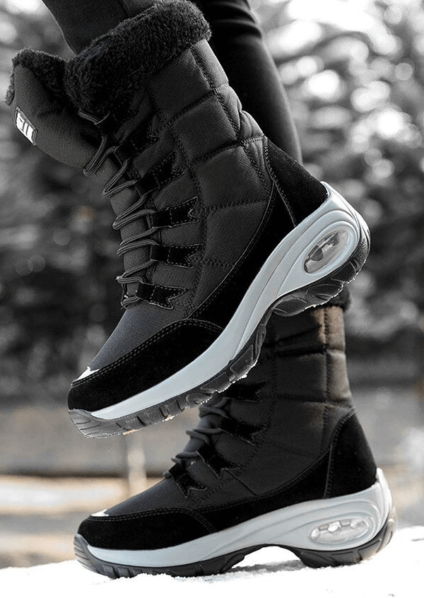 Women's waterproof snow boots with leather upper and rubber sole for winter trekking.