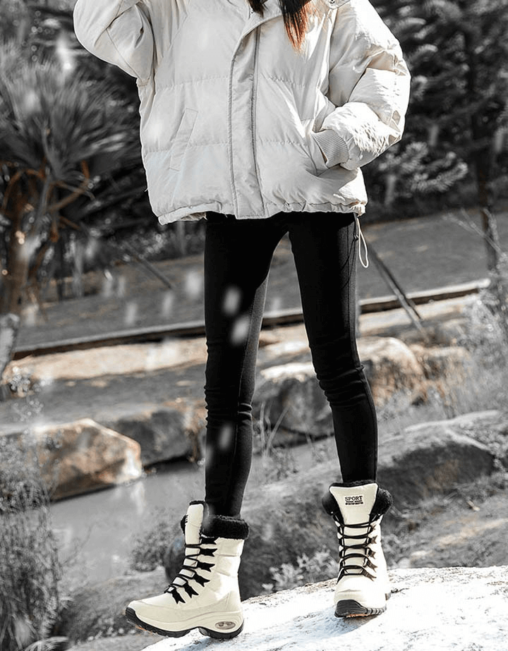 Woman wearing waterproof snow boots, standing on icy terrain in winter fashion, showcasing SF0288 outdoor trekking shoes.