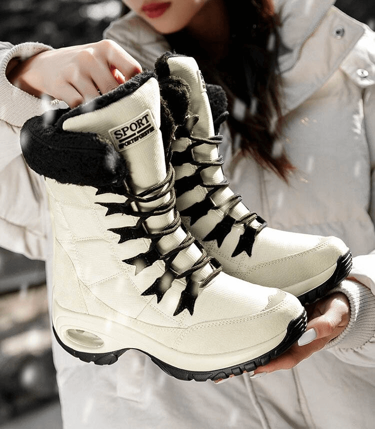 Women's waterproof snow boots in cream with black fur lining, featuring durable rubber soles and a stylish design for winter trekking.