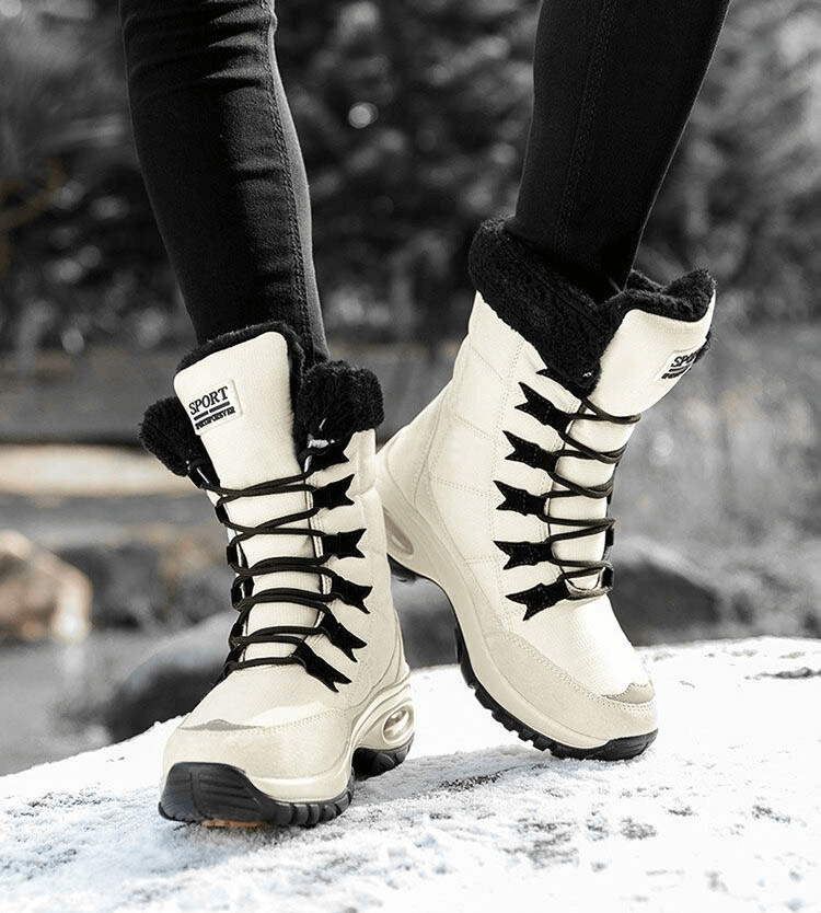 Women wearing waterproof warm trekking snow boots for outdoor winter adventures, showcasing durable leather and rubber design on icy terrain.