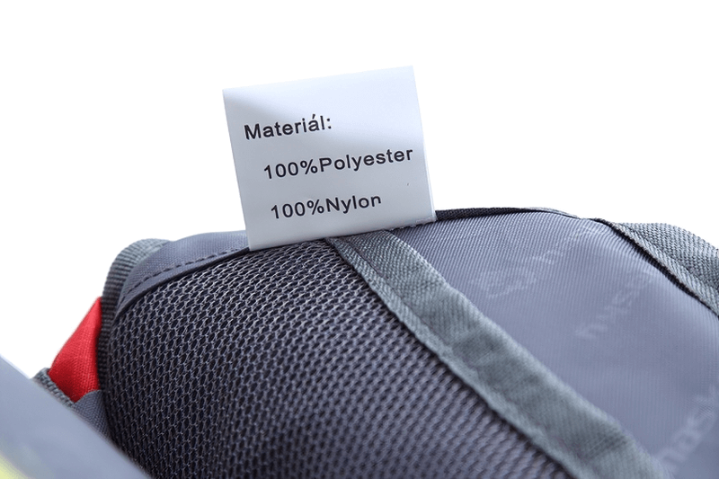 Close-up of an Outdoor Sports Running Waist Bag label showing 100% polyester and nylon materials for durability.