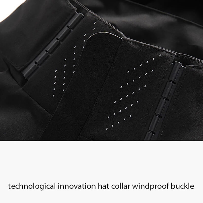 Close-up of the innovative windproof buckle on a black thin windbreaker, highlighting its technological design.