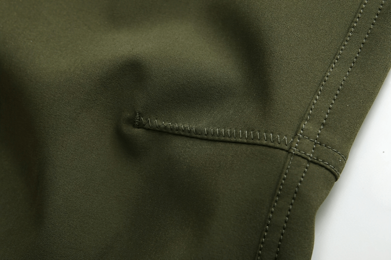 Close-up of durable polyester fabric and stitching on men's windproof ski pants SF0735 in olive green.