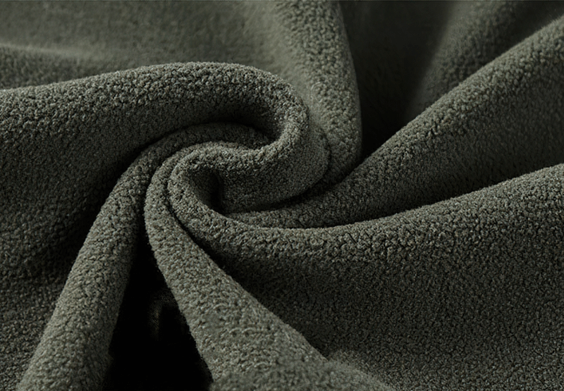 Close-up of soft green fleece fabric texture used in outdoor hiking jacket SF0686, highlighting its warmth and comfort.