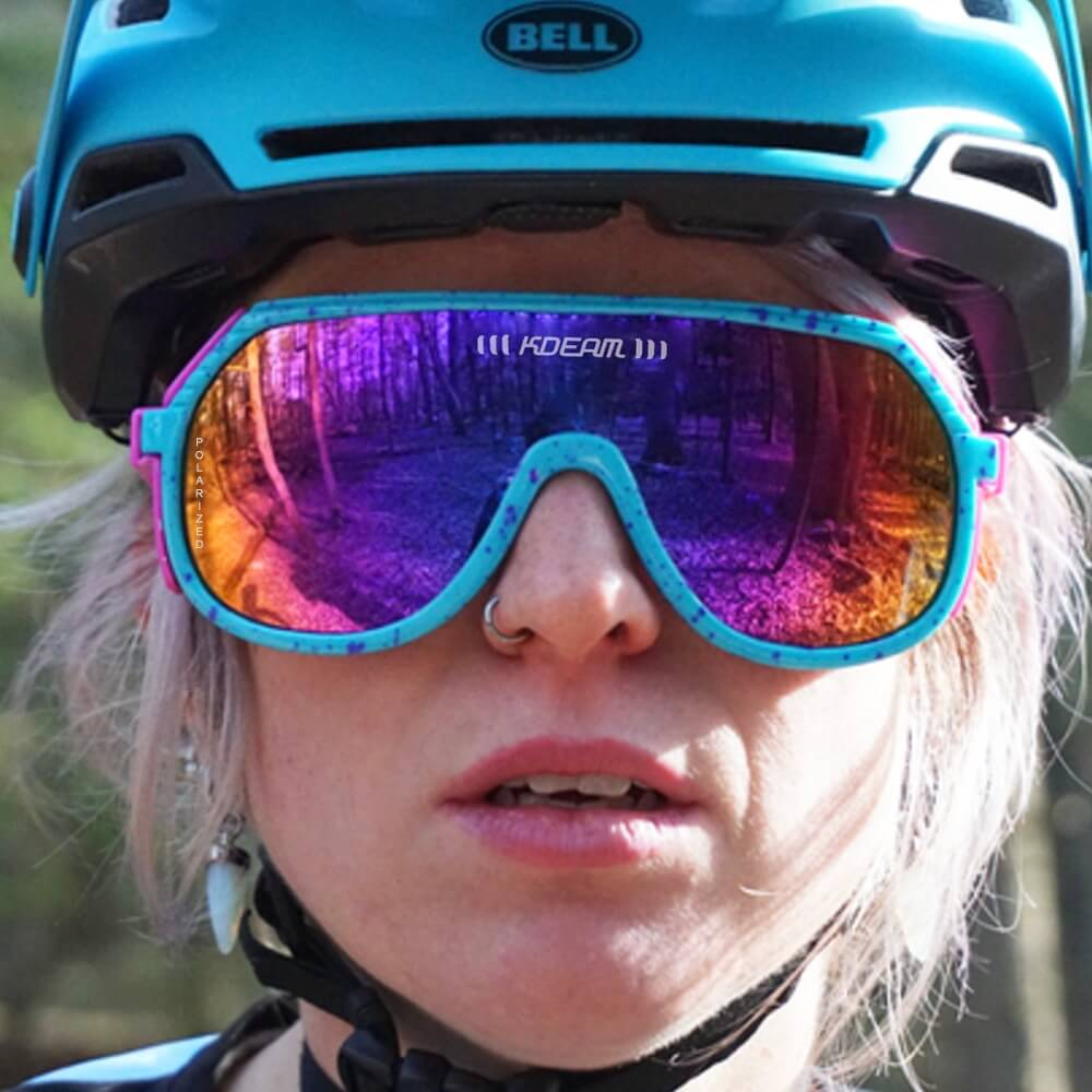 Cyclist wearing polarized anti-reflective sports bicycling sunglasses SF0963 with mirrored lenses in a forest setting.