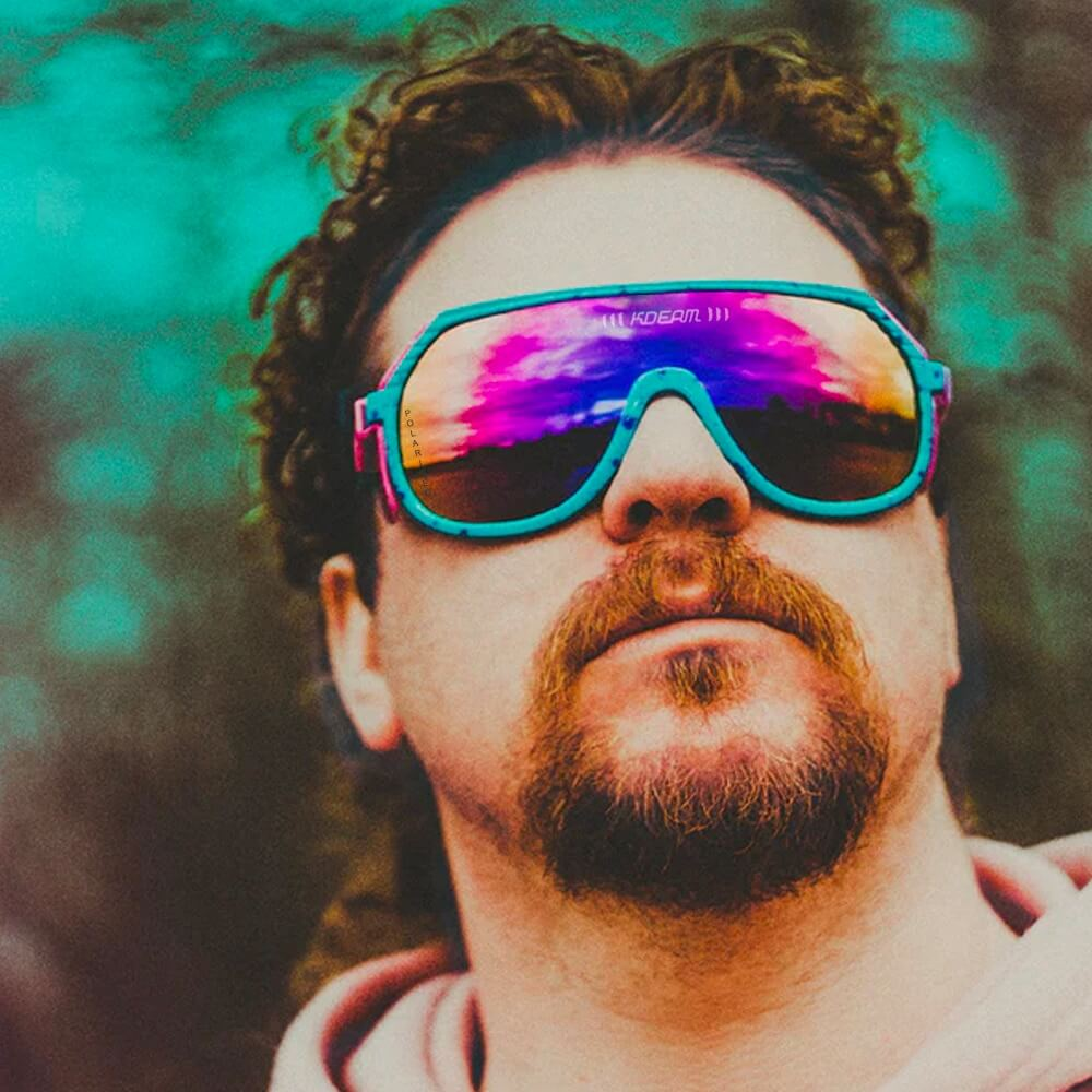 Colorful reflective sunglasses with vibrant design, worn by a person outdoors showcasing style and UV protection.