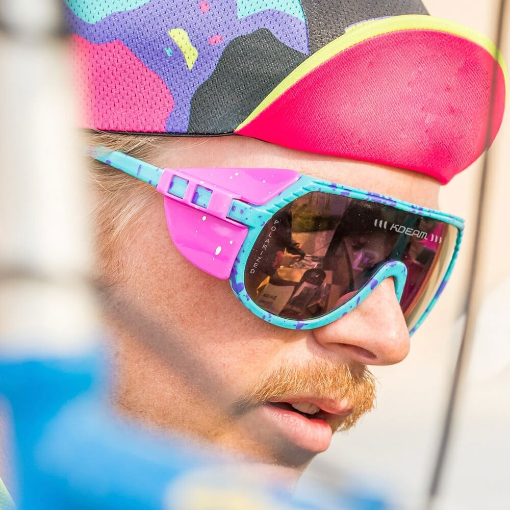 Cyclist wearing colorful polarized sports bicycling sunglasses, highlighting stylish design and UV protection.