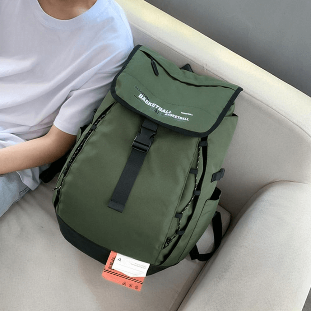 Green portable sports basketball backpack with ball pocket, adjustable strap, and durable oxford fabric, resting on a sofa.