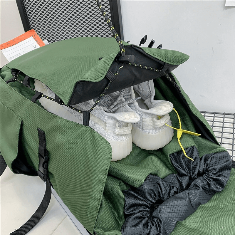 Green sports backpack with basketball pocket and visible sneakers, ideal for outdoor activities and sports enthusiasts.