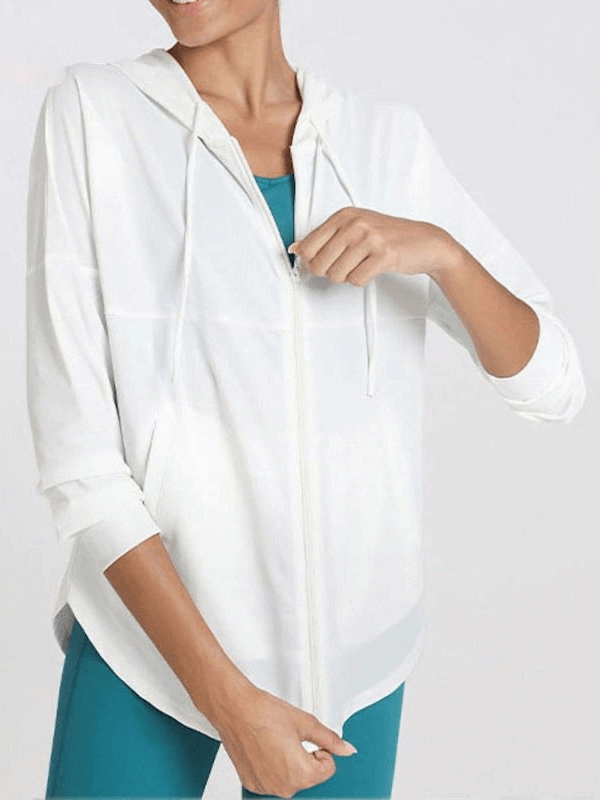 Woman wearing white sports loose jacket with hood, perfect for jogging, running, and yoga. Lightweight, breathable, and quick-drying.