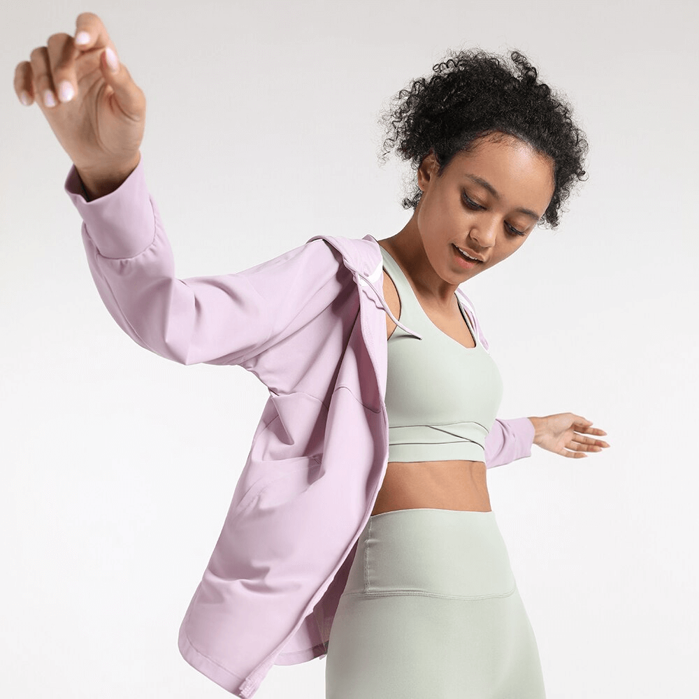 Woman wearing pink quick-dry casual training hoodie with a zipper, perfect for yoga and fitness, showcasing comfort and style.