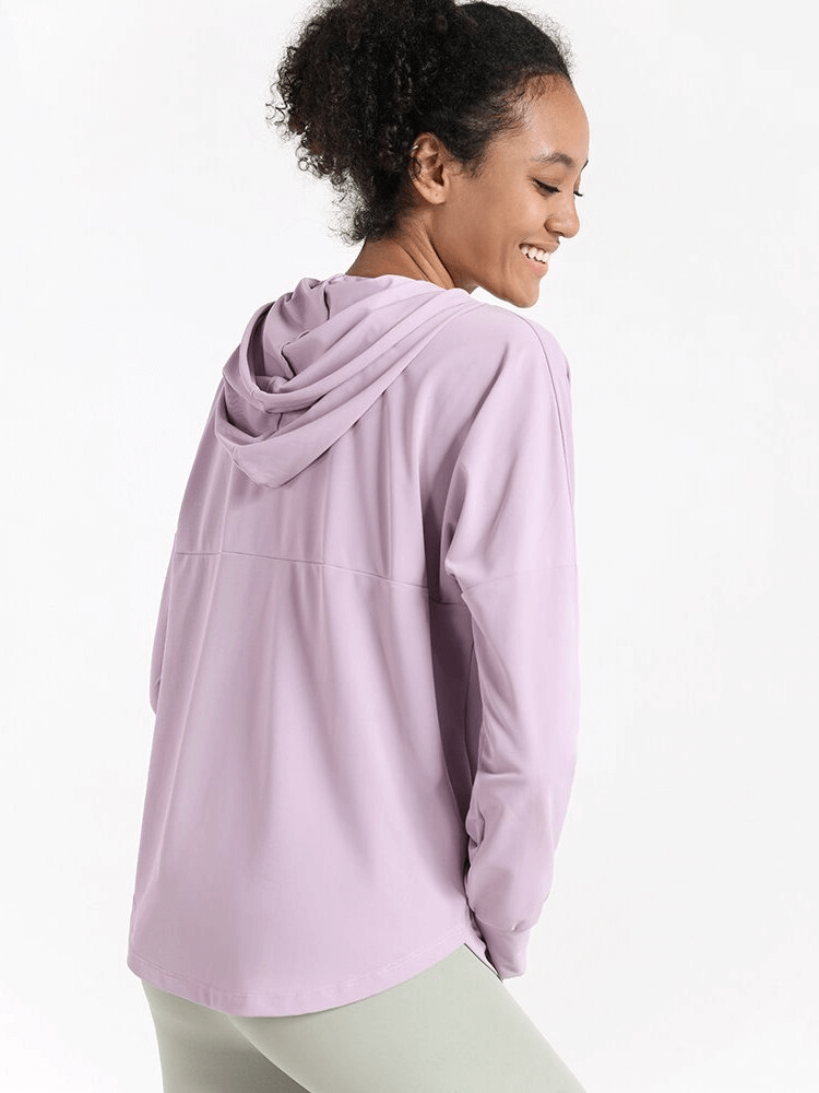 Woman wearing a lilac Quick Dry Loose Casual Training Hoodie with Zipper for women, showing breathable and lightweight fabric.