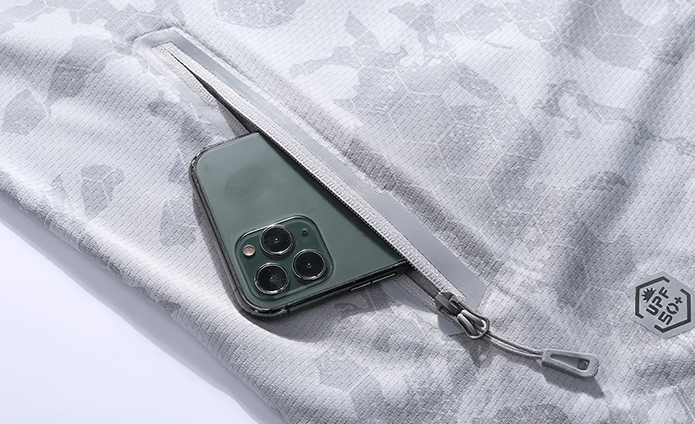 Close-up of ultrathin cycling jacket pocket with reflective zipper, holding a smartphone, featuring UV 50+ protection.