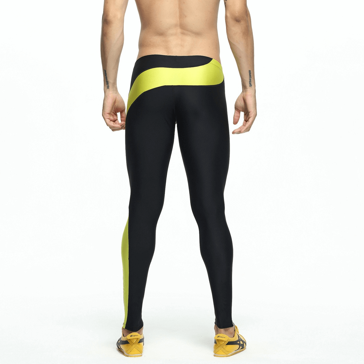 Back view of men's quick-drying compression running leggings in black and yellow, providing breathable support and comfort for workouts.