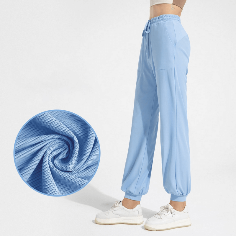 Light blue quick-drying women's sports training pants with pockets, featuring lightweight nylon fabric and drawstring waist, SF1262.