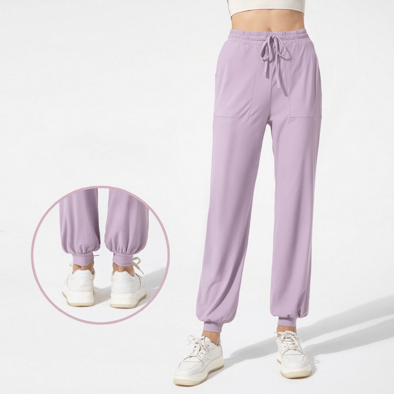 Quick-drying sports lightweight women's training pants in purple with pockets and ankle-length fit, ideal for yoga and active wear.