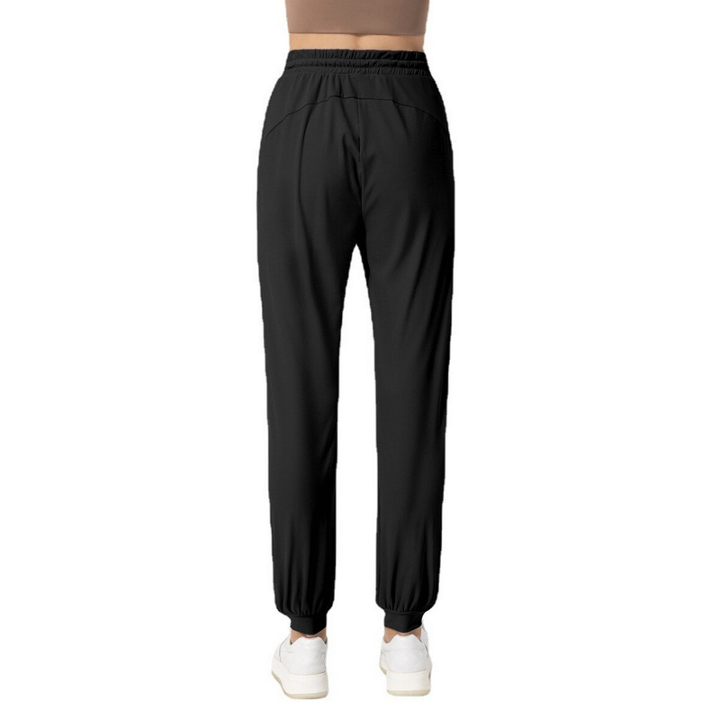 Back view of Quick-drying Women's Training Pants in black, lightweight and moisture-wicking with convenient pockets, perfect for active yoga sessions.