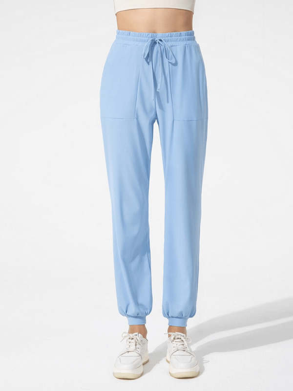 Quick-drying sports lightweight women's training pants with pockets in light blue, featuring moisture-wicking fabric and ankle-length fit.