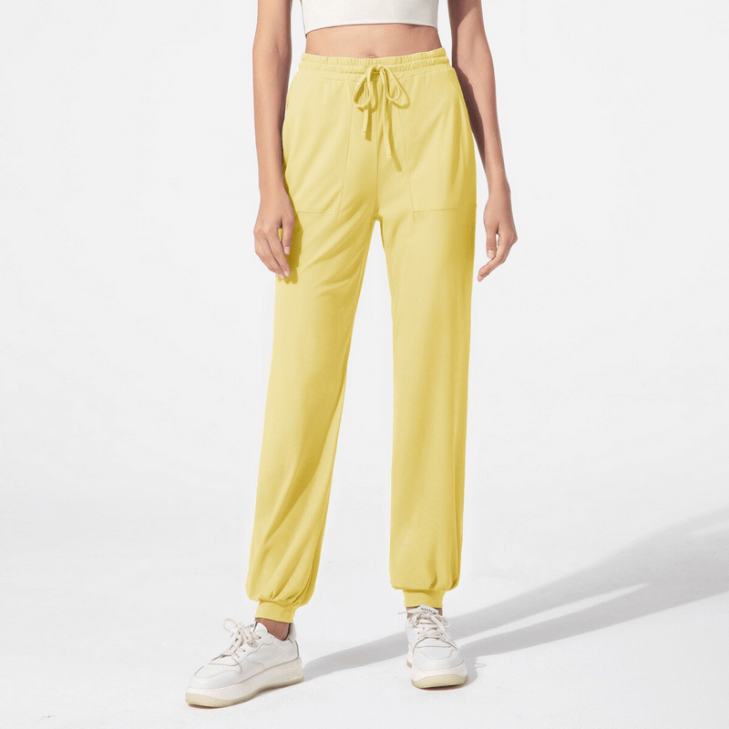 Yellow quick-drying women's training pants with pockets, featuring a lightweight, moisture-wicking design ideal for active lifestyles.