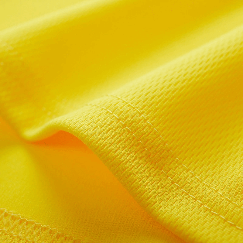 Close-up of yellow quick-drying polyester fabric for a men's sports T-shirt, showcasing moisture-wicking and breathable texture.