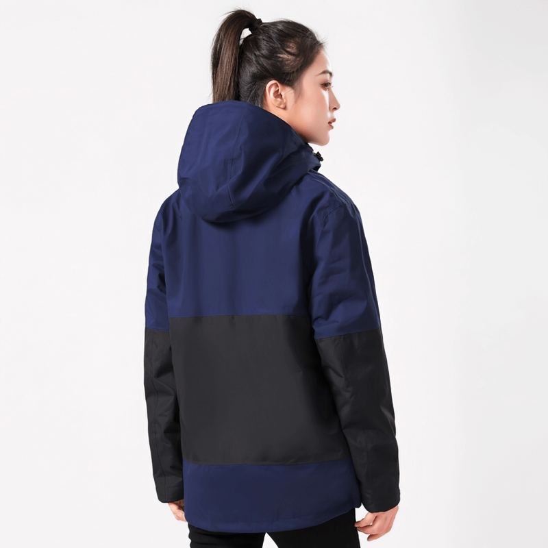 Model wearing navy reflective two-piece softshell skiing jacket, ideal for outdoor adventures, featuring waterproof and thermal design.