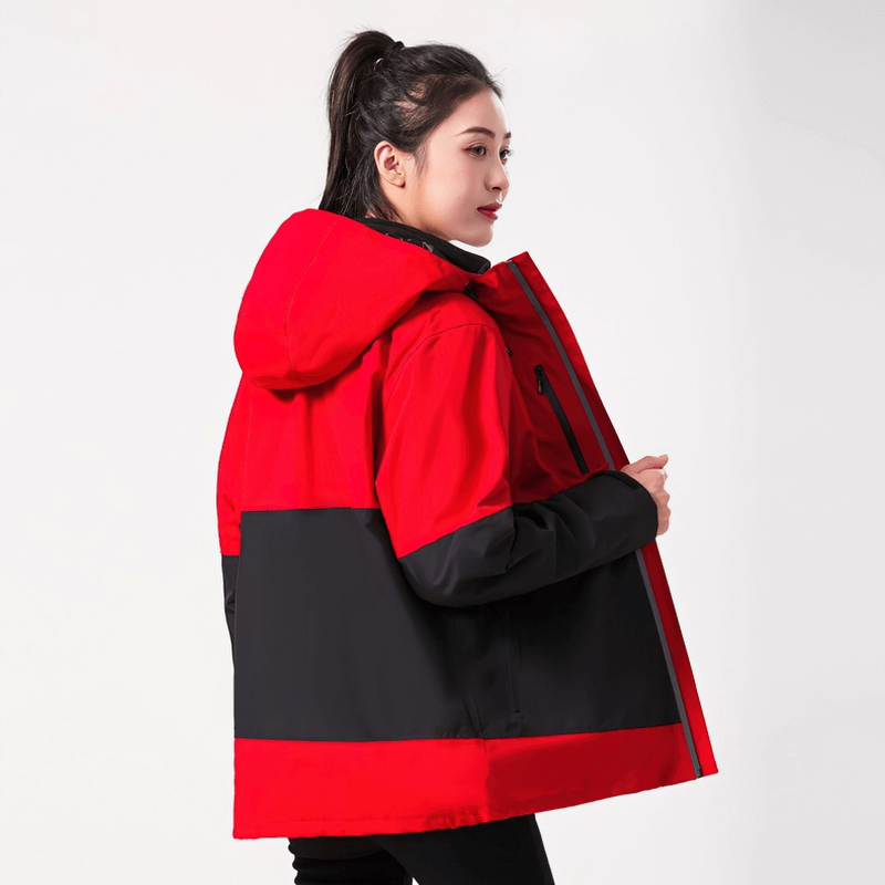 Model wearing red and black Reflective Two-Piece Warm Softshell Skiing Jacket, perfect for camping and hiking adventures.