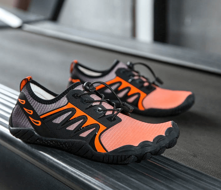 Bright orange water sneakers with rubber toe protection and adjustable laces, featuring a quick-drying stretch fabric for swimming.