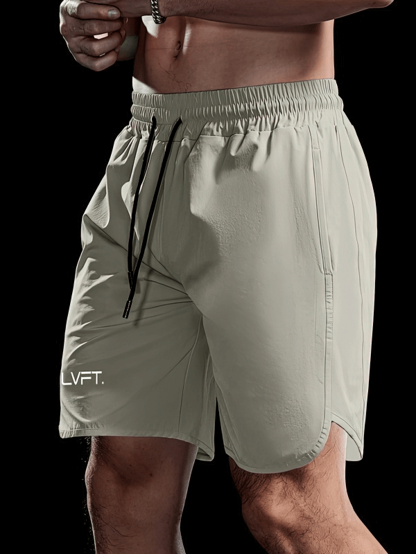 Quick-drying men's training shorts in beige, featuring sweat-wicking nylon material, perfect for running and intense workouts.