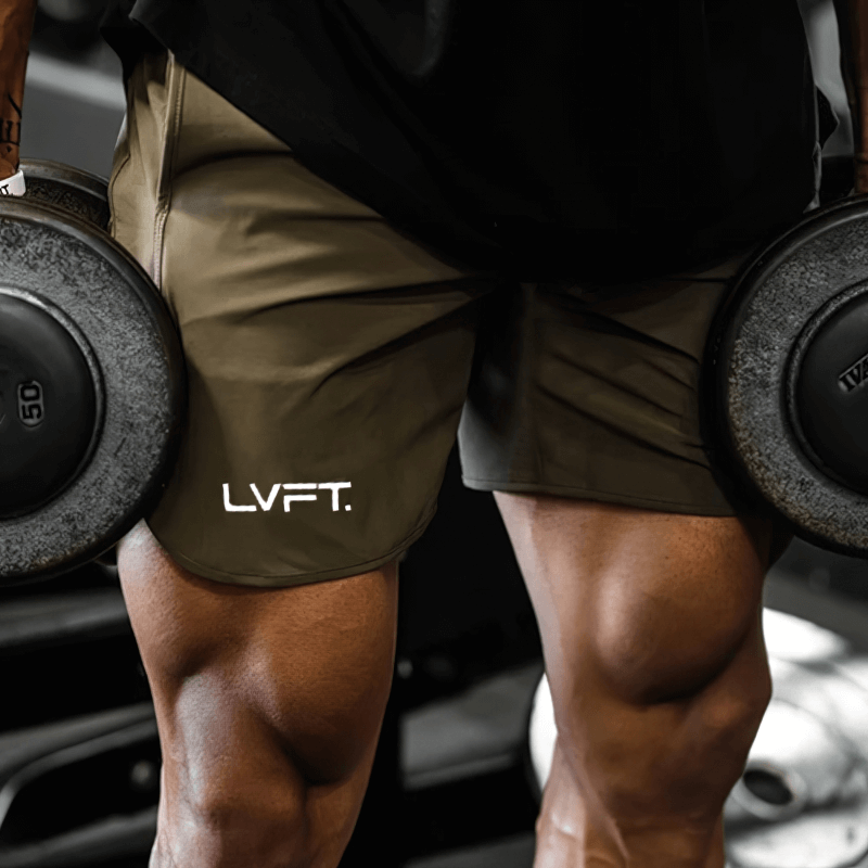 Man lifting weights in quick-drying sports training shorts, showcasing breathable nylon material for comfort and sweat-wicking technology.
