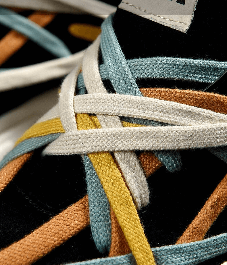 Close-up of colorful laces on running thick bottom leather sneakers, showcasing vibrant blue, white, yellow, and orange hues.