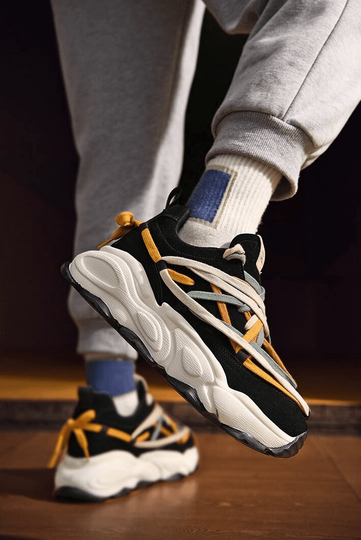 Person wearing running thick bottom leather sneakers with multicolored laces, showcasing stability and style.