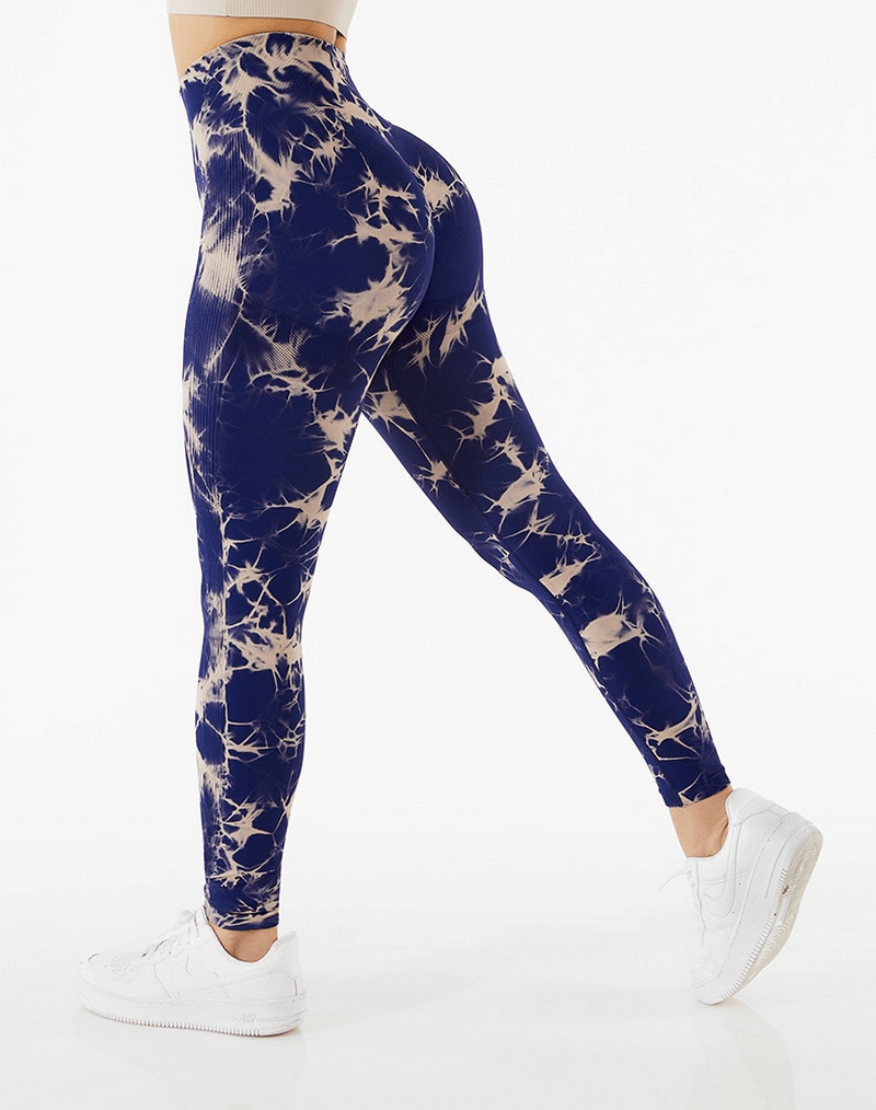Woman wearing high waist tie-dye leggings, demonstrating leg stretch. Perfect for fitness and yoga with seamless design, SKU SF1137.